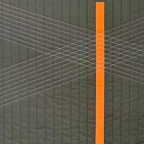 Gray quilt with orange stripe.